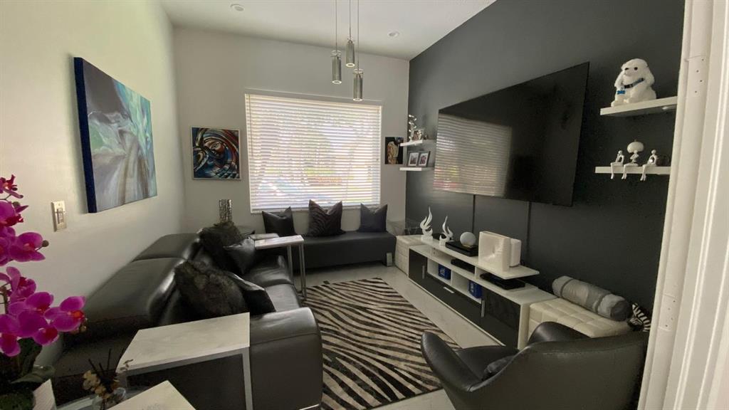 830 Bailey Street Boca Raton, FL 33487 - Photo 4 of 24 a living room with furniture wooden floor and a flat screen tv