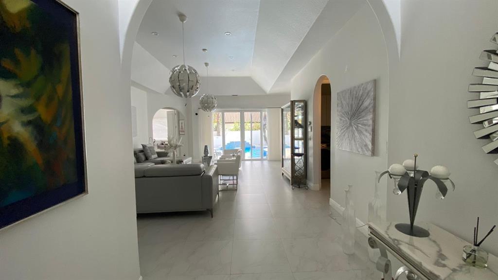 830 Bailey Street Boca Raton, FL 33487 - Photo 5 of 24 a living room with furniture and a chandelier