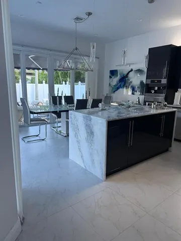 a kitchen with stainless steel appliances granite countertop a sink and a stove