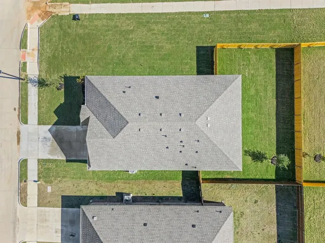 an aerial view of a house with a yard