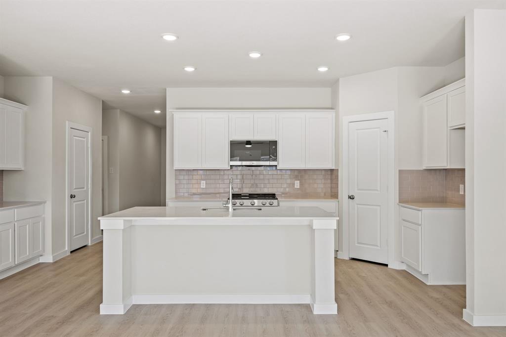 1012 Verde Valley Lane Crowley, TX 76036 - Photo 5 of 19 a large white kitchen with kitchen island a sink stainless steel appliances and cabinets