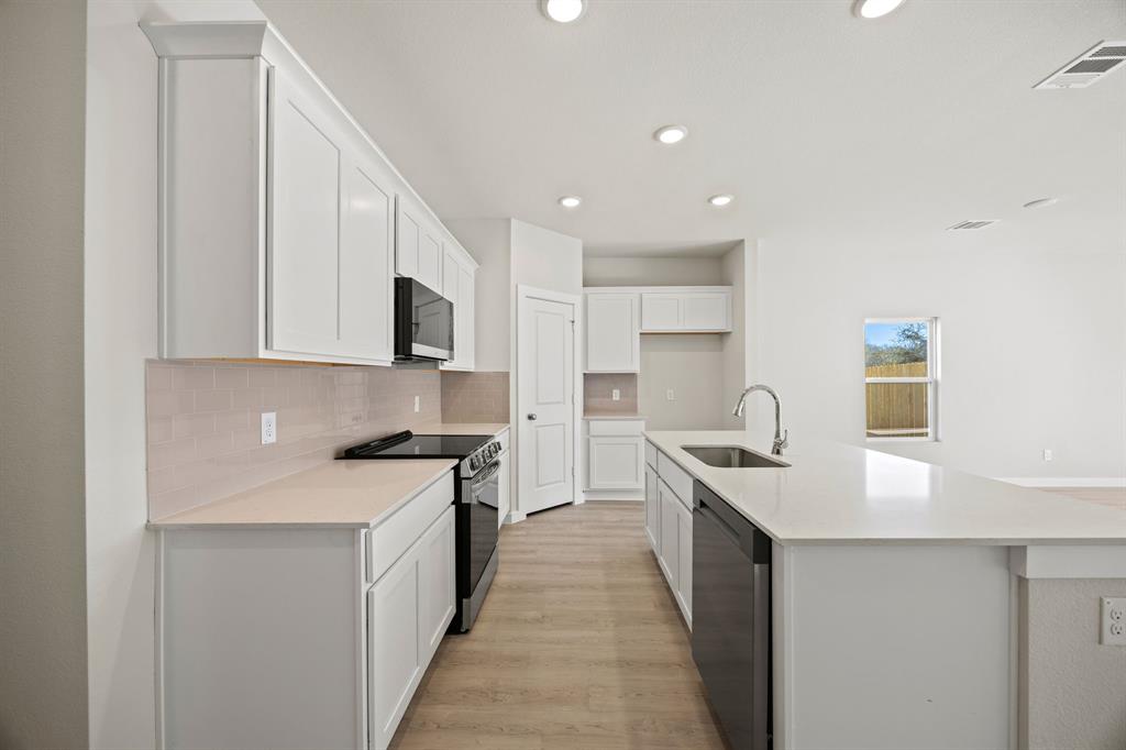 1012 Verde Valley Lane Crowley, TX 76036 - Photo 6 of 19 a kitchen with stainless steel appliances granite countertop a sink and a stove