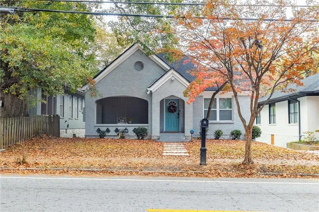 a backyard of a house with yard and tree