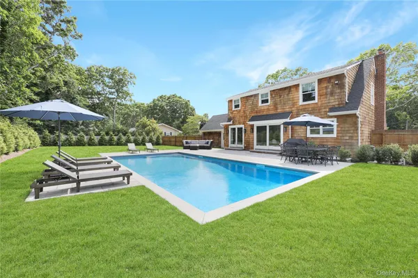 a view of a house with a yard patio and swimming pool