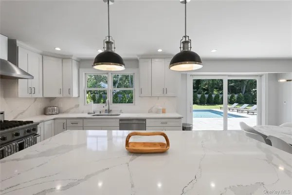 a kitchen with a sink and a large window