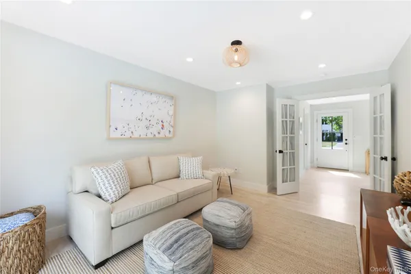 a living room with furniture and a painting