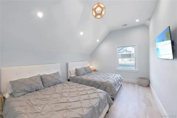 a bedroom with two beds and a window