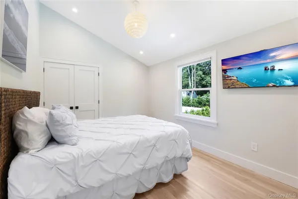 a large white bed in a white room