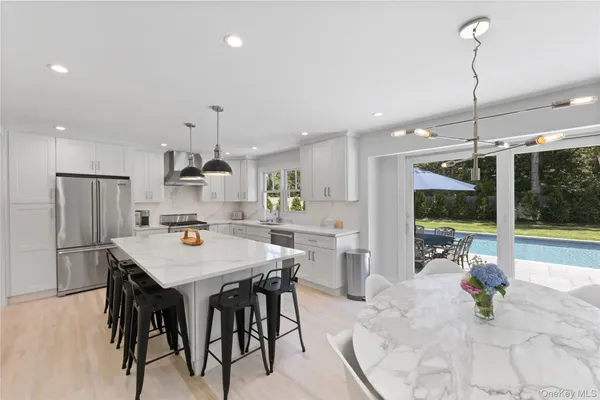 a kitchen with a table chairs refrigerator and microwave