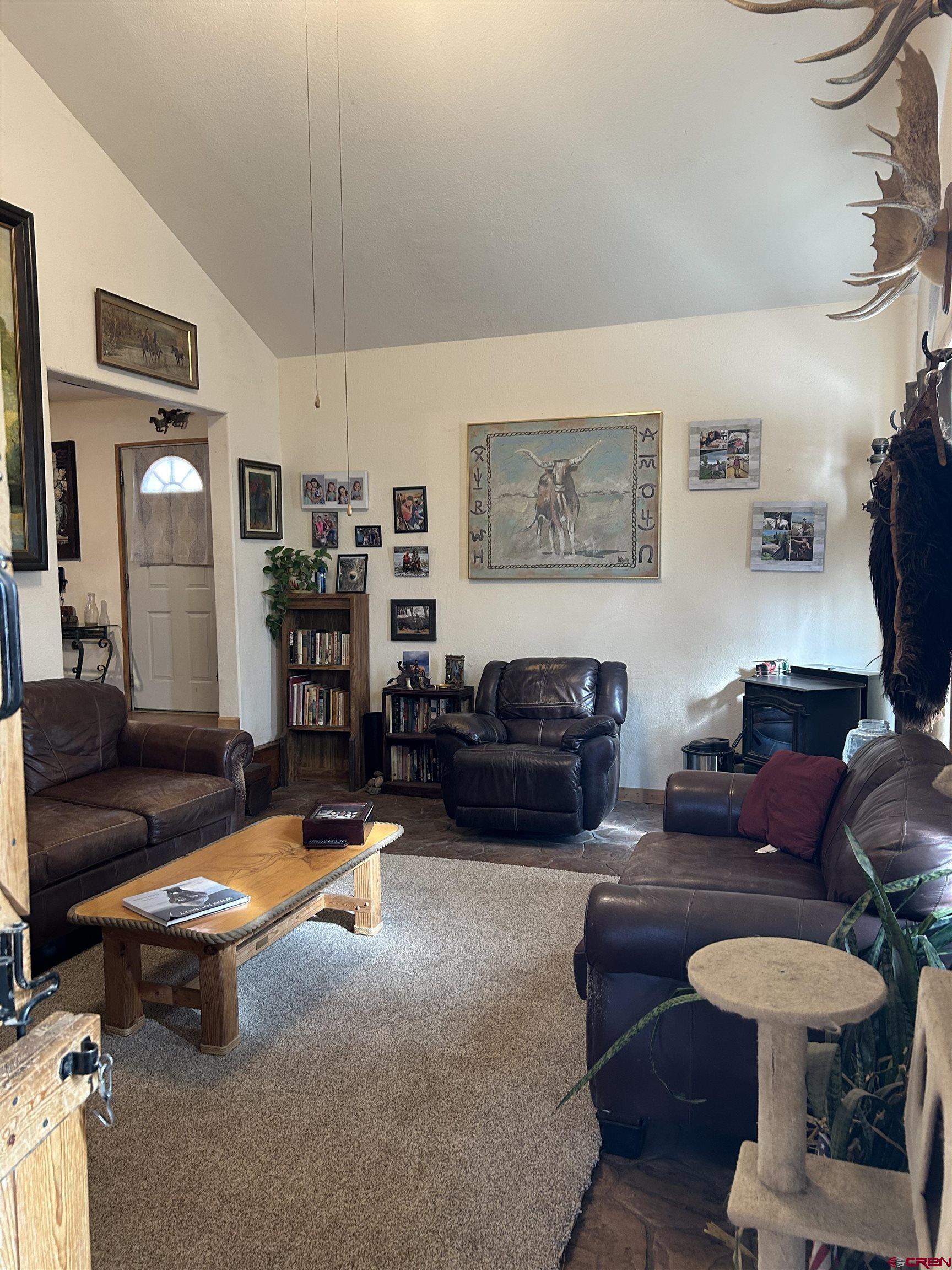 27701 BB Road Nucla, CO 81424 - Photo 16 of 27 a living room with furniture a flat screen tv and a table
