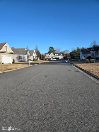 a view of a street with a cars parked in front of it