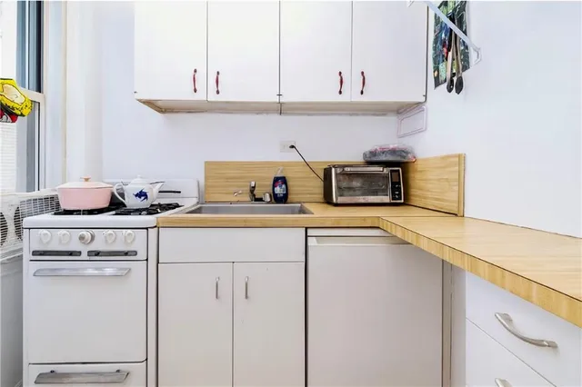 a kitchen with appliances cabinets and a counter top space