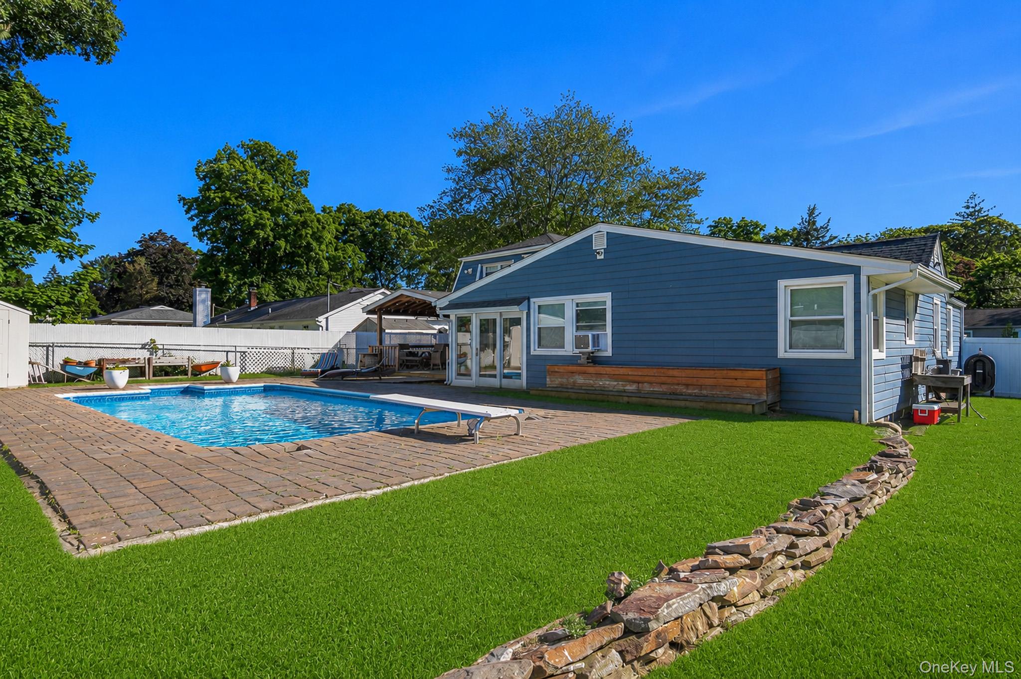 33 Lillian Road Nesconset, NY 11767 - Photo 32 of 42 Another View Of The Spectacular Entertainer's Backyard Offering A Saltwater In Ground Pool With A Diving Board, Expansive Paver Patios & Paver Pool Surround, And The Pool Is Always Warm Because Of Constant Direct Sunlight.