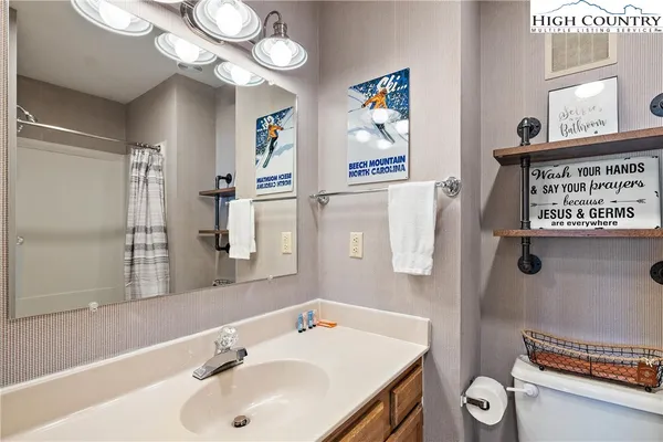 a bathroom with a sink a mirror and a shower