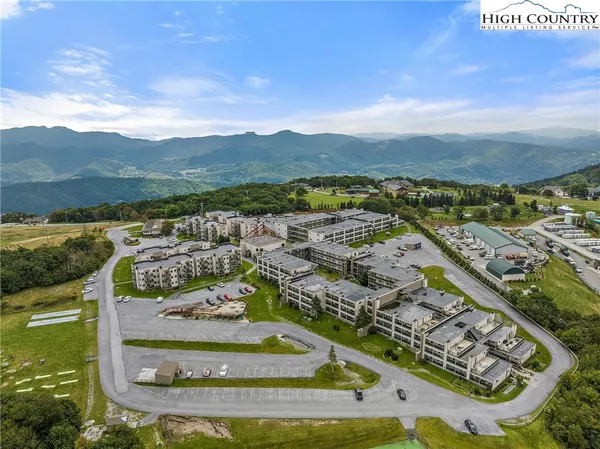 an aerial view of residential houses with outdoor space and street view