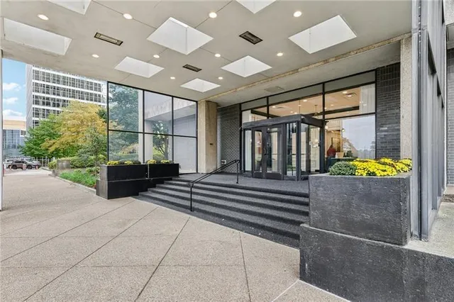 a lobby with furniture and potted plants