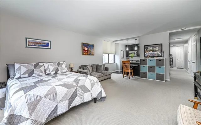 a spacious bedroom with a bed and a desk