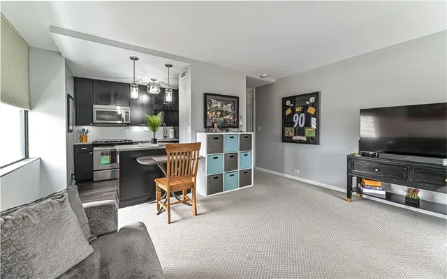 a view of a livingroom with furniture and a flat screen tv