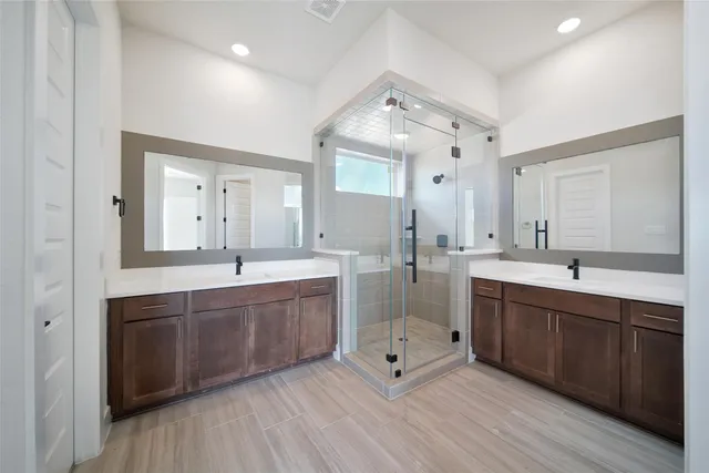 a spacious bathroom with a double vanity sink mirror and