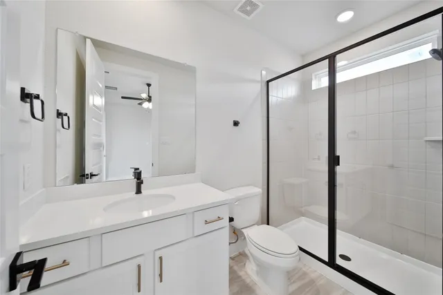 a bathroom with a sink toilet and shower