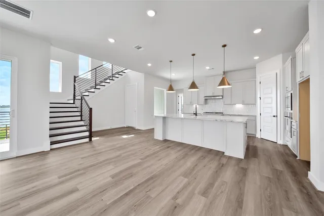 a large kitchen with a lot of counter space and stainless steel appliances