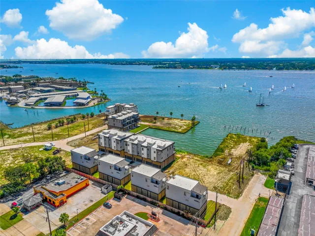 an aerial view of a houses with ocean view