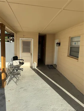 a front view of a house with lots of trees in the background