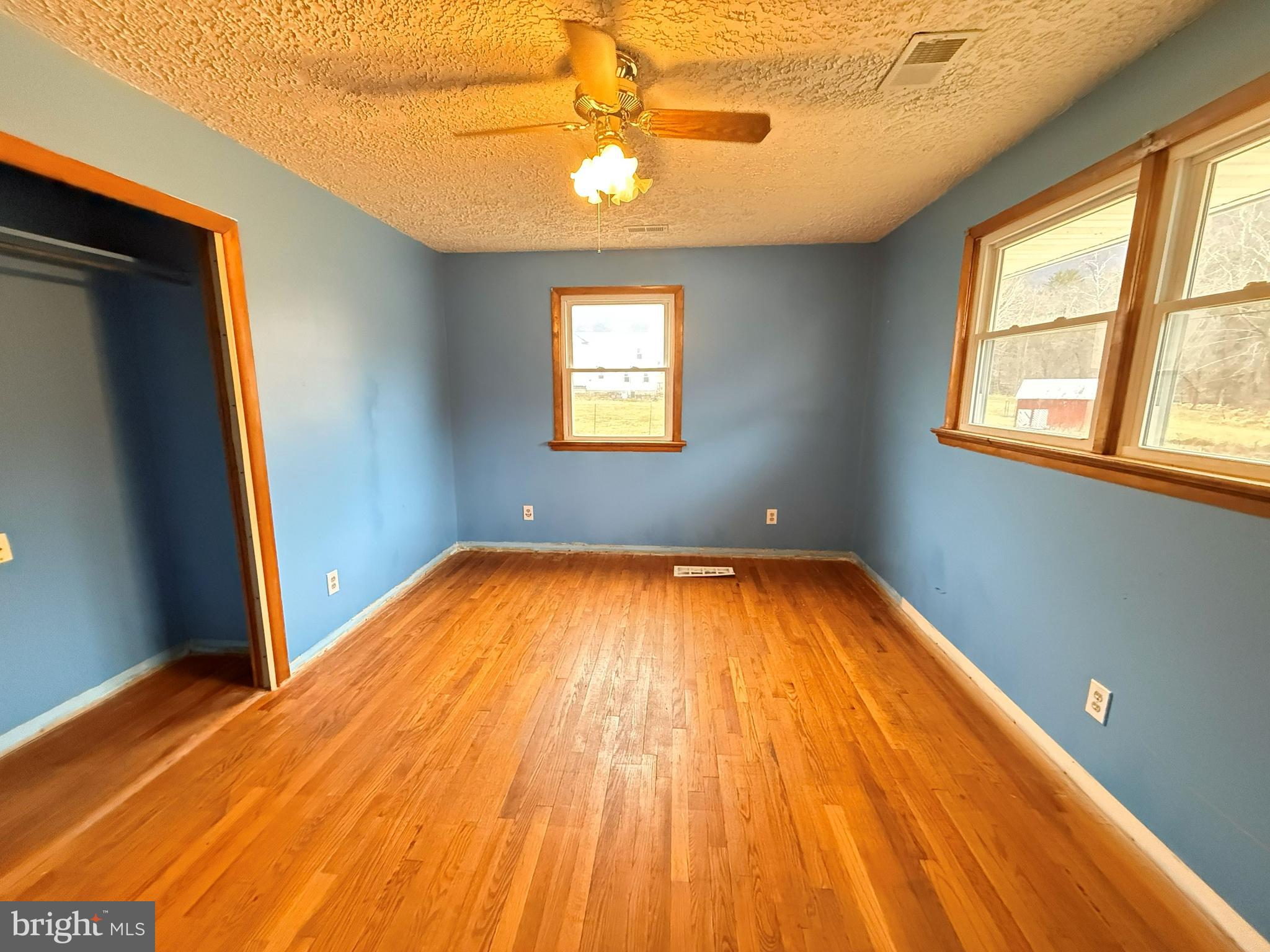 82 Broad Run Road Bentonville, VA 22610 - Photo 13 of 21 a view of empty room with wooden floor and fan