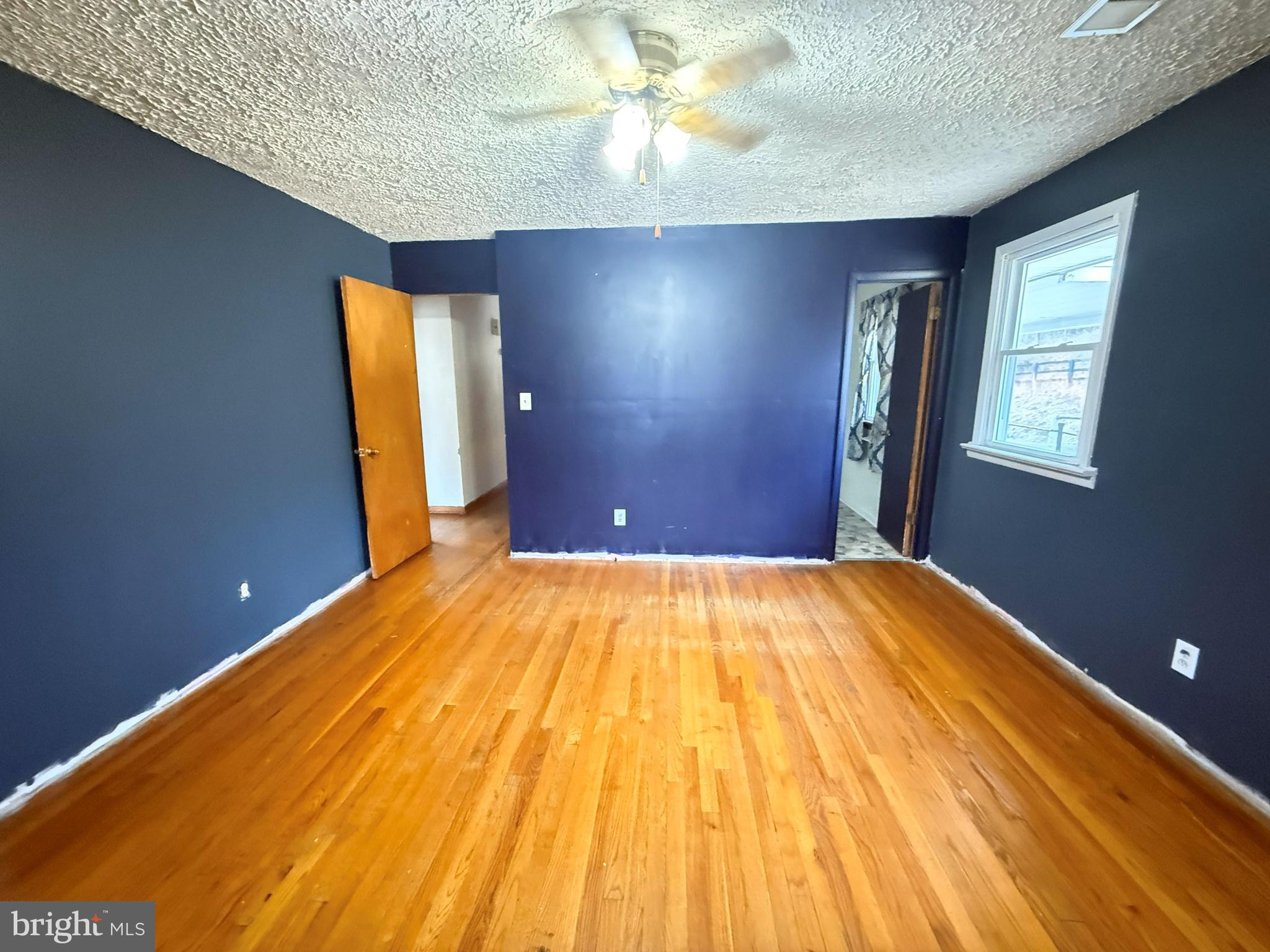 82 Broad Run Road Bentonville, VA 22610 - Photo 9 of 21 a view of empty room with window and wooden floor