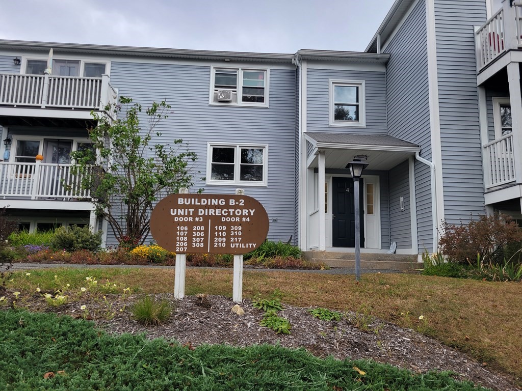 46 Evergreen Road, Unit 210 Leeds, MA 01053 - Photo 1 of 34 a front view of a house with garden