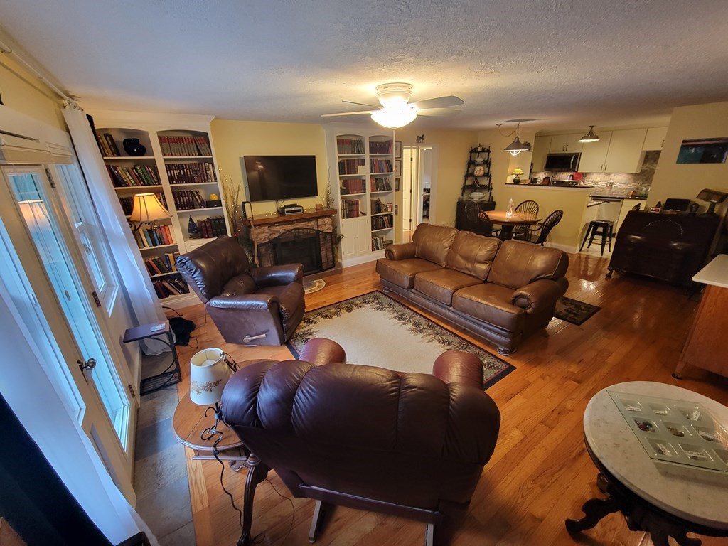 46 Evergreen Road, Unit 210 Leeds, MA 01053 - Photo 12 of 34 a living room with furniture a flat screen tv and kitchen view