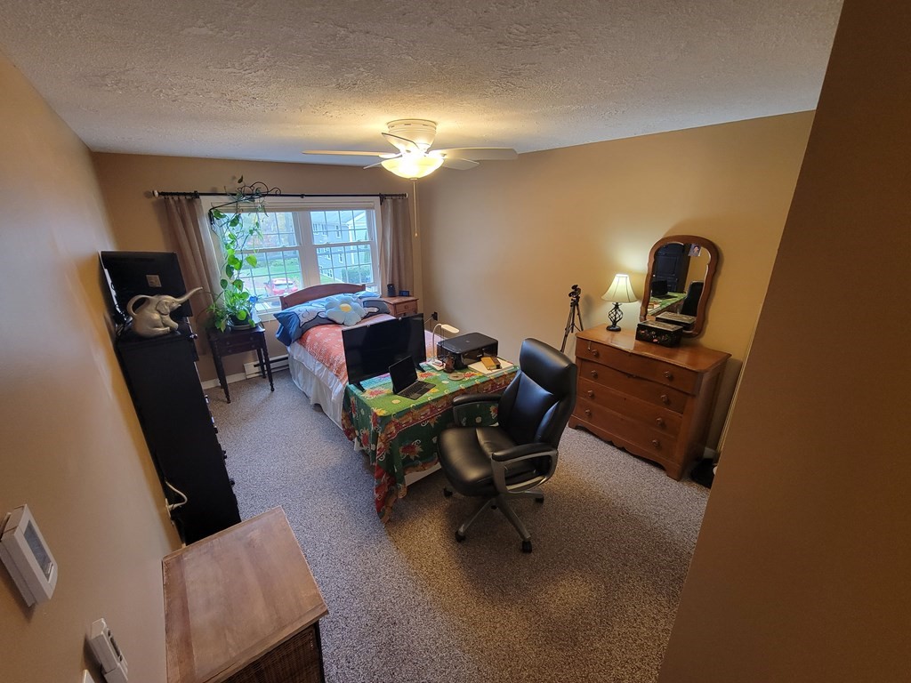 46 Evergreen Road, Unit 210 Leeds, MA 01053 - Photo 32 of 34 a living room with furniture and a window