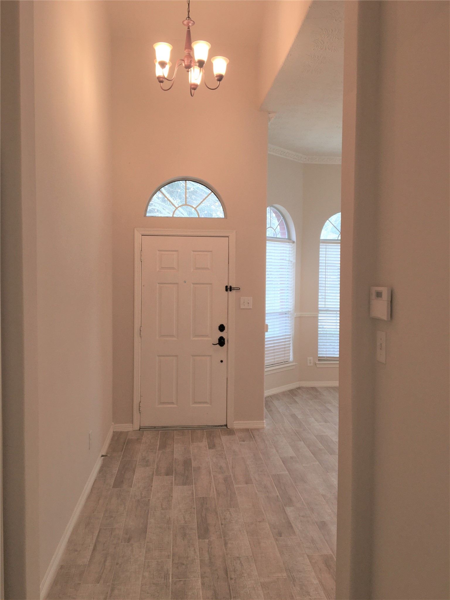 2214 Valley View Crossing Conroe, TX 77304 - Photo 6 of 23 wooden floor in an empty room with a window