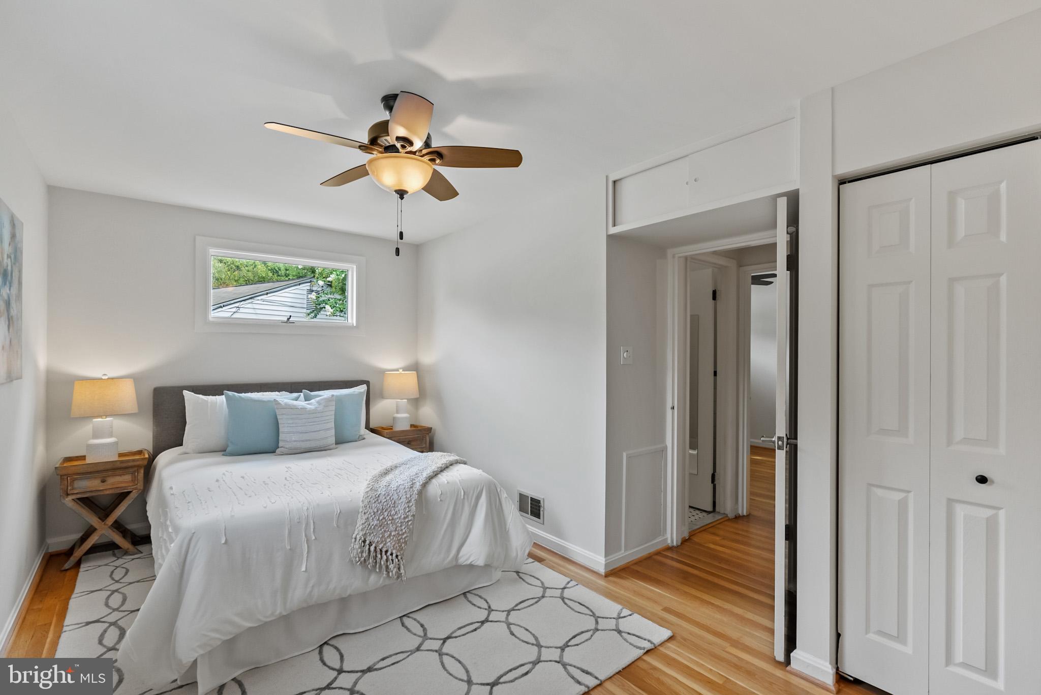 4703 Wyaconda Road Rockville, MD 20852 - Photo 19 of 40 a bedroom with a bed and a chandelier