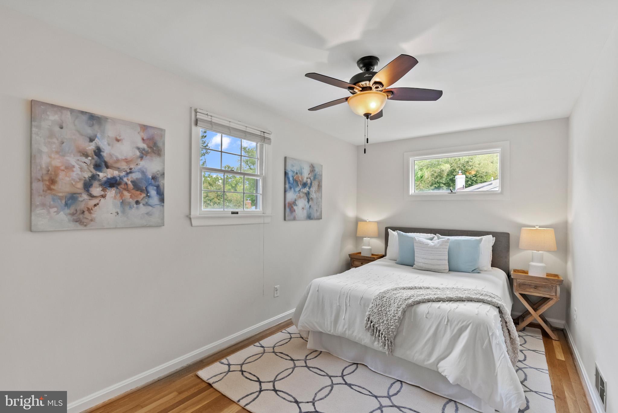 4703 Wyaconda Road Rockville, MD 20852 - Photo 20 of 40 a bedroom with a bed and a chandelier