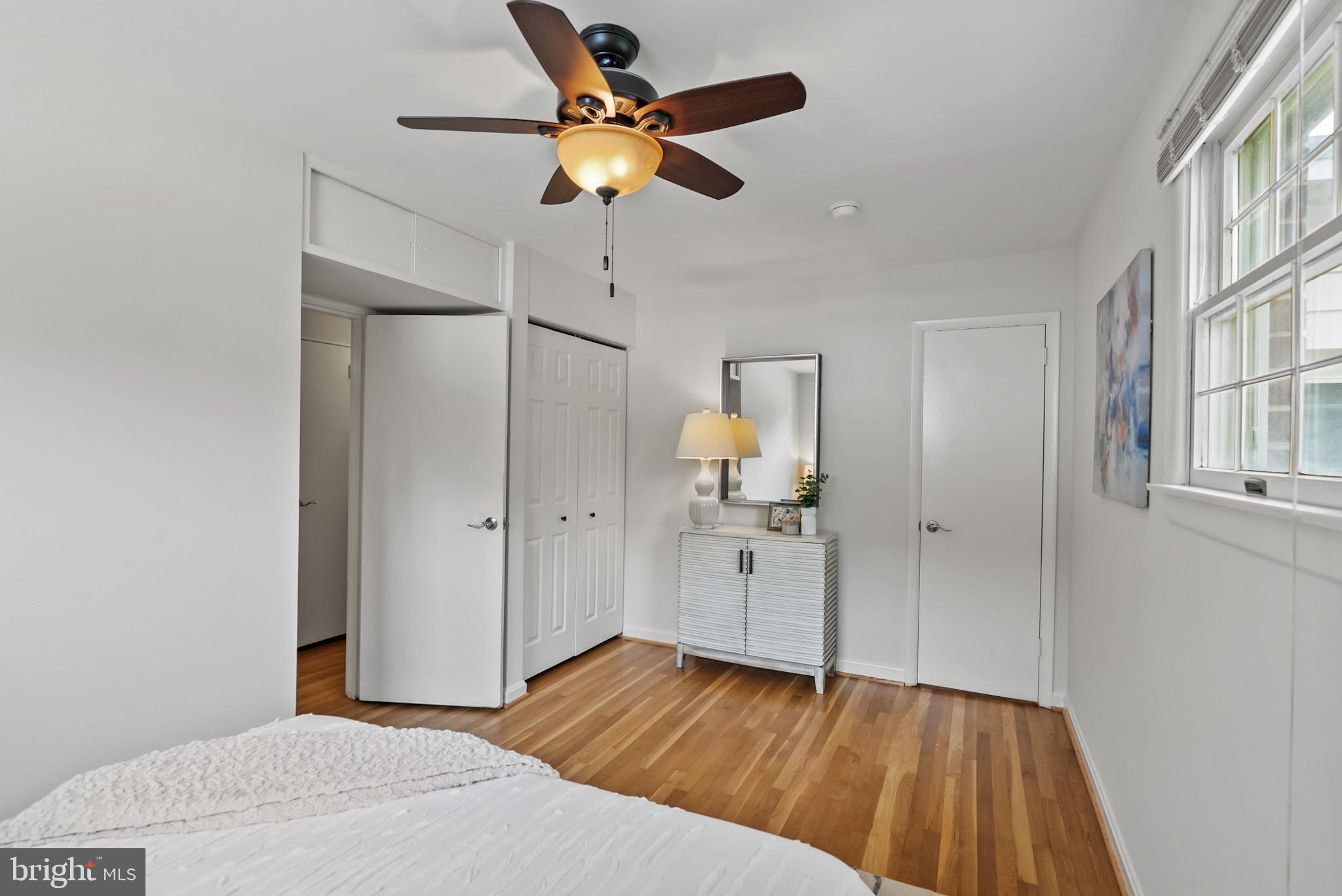 4703 Wyaconda Road Rockville, MD 20852 - Photo 21 of 40 a bedroom with a bed and a chandelier