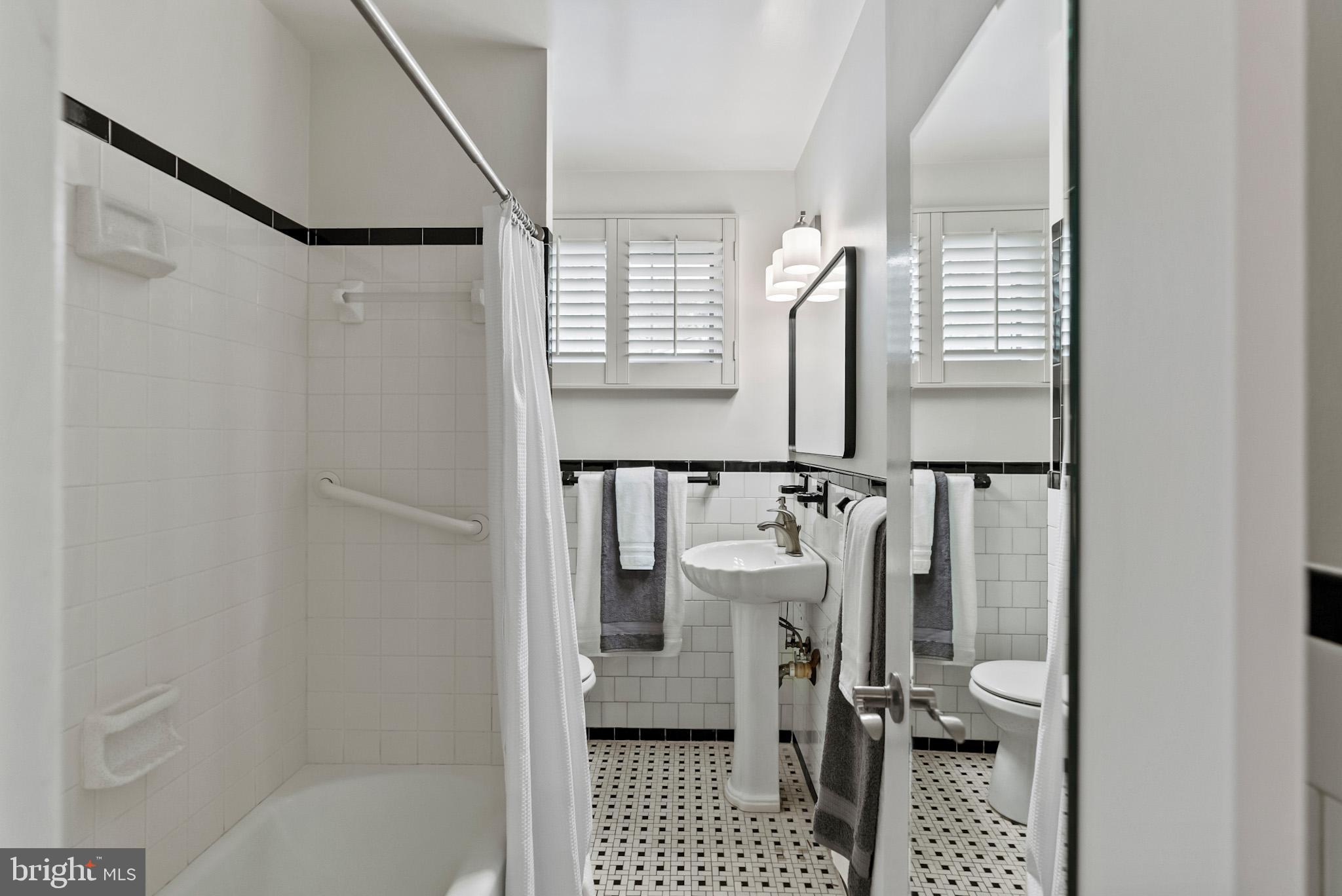 4703 Wyaconda Road Rockville, MD 20852 - Photo 22 of 40 a bathroom with a sink toilet and shower