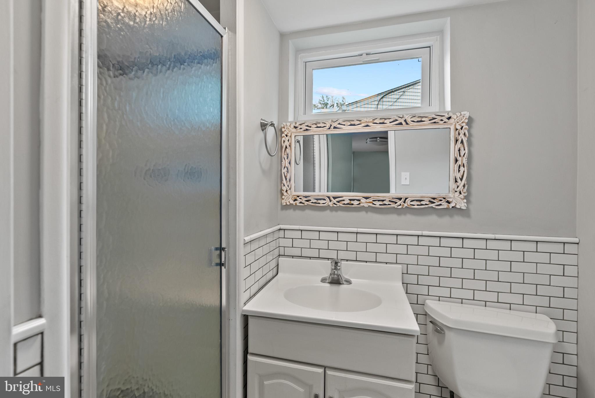 4703 Wyaconda Road Rockville, MD 20852 - Photo 36 of 40 a bathroom with a sink toilet and mirror