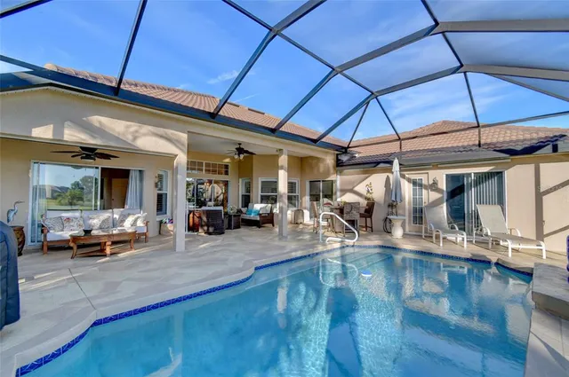 a view of a patio with table and chairs under an umbrella
