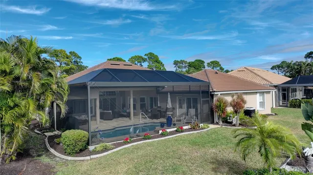 a view of house with yard and outdoor seating