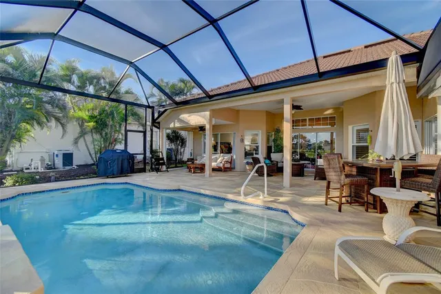 a view of a patio with table and chairs under an umbrella