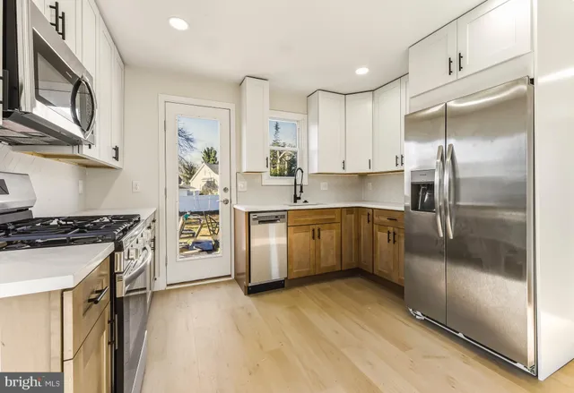 a kitchen with a sink stove and refrigerator