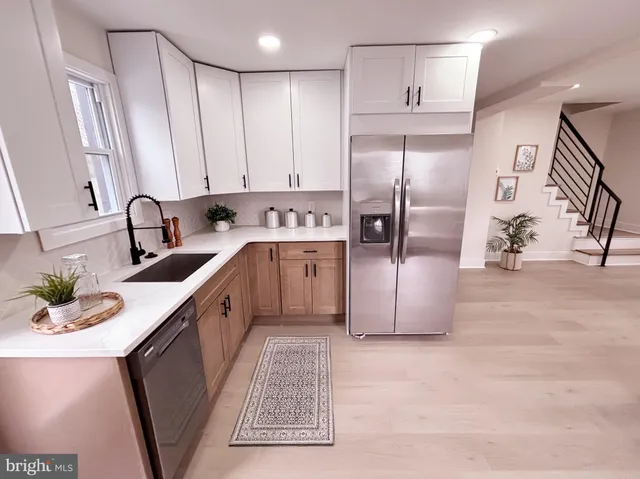 a kitchen with stainless steel appliances cabinets a sink and a counter top space