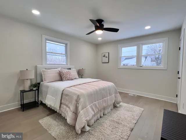 a spacious bedroom with a bed and a painting