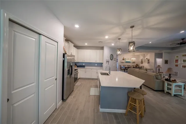 a large kitchen with a table and chairs