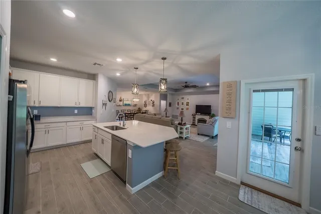 a kitchen with counter top space and wooden floor