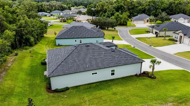 an aerial view of a house with swimming pool garden and patio