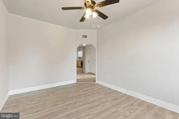 a view of an empty room and window and wooden floor