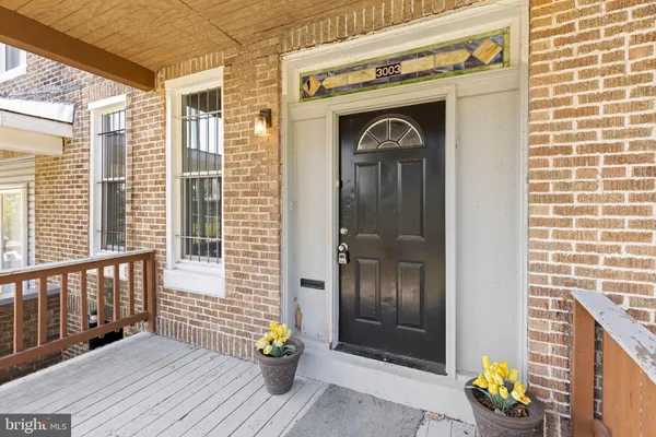 a front view of a house with outdoor seating