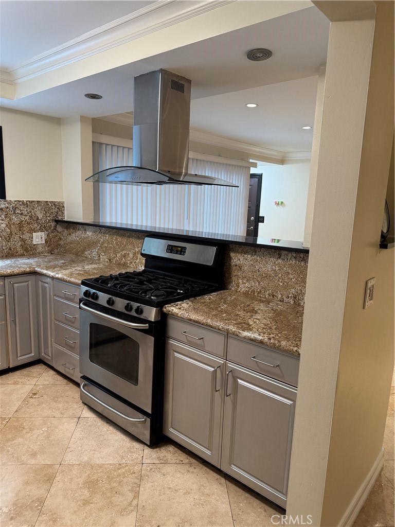 11370 Sunset Boulevard, Unit B Los Angeles, CA 90049 - Photo 20 of 27 a kitchen with granite countertop a stove sink and cabinets